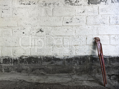 Old adjustable wrench standing at stone wall