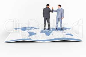 Composite image of businessmen shaking hands