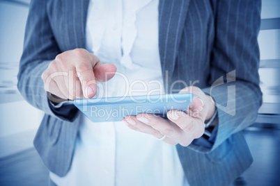 Composite image of businesswoman using her tablet Composite image of businesswoman using her tablet