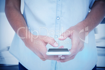 Composite image of close up of woman using her smartphone