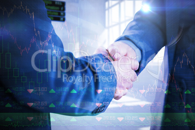 Composite image of business people shaking hands close up