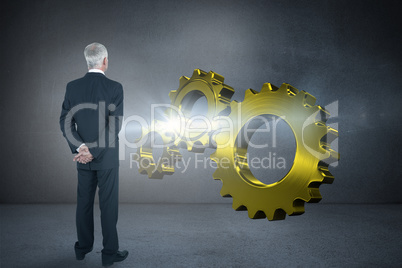 Composite image of rear view of mature businessman posing