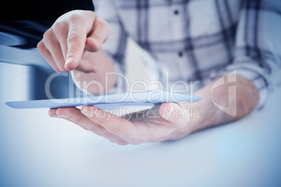 Composite image of casual man using tablet pc Composite image of casual man using tablet pc
