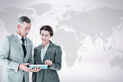 Composite image of business people looking at tablet