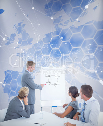 Composite image of manager presenting whiteboard to his colleagu