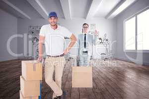 Composite image of happy delivery man leaning on trolley of boxe