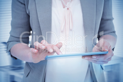Composite image of close up of woman using tablet