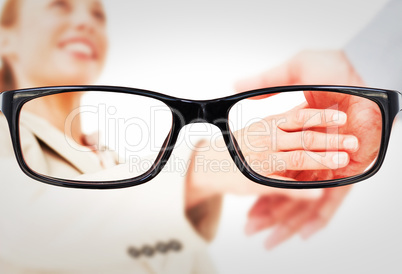 Composite image of low angleshot of a woman shaking hands