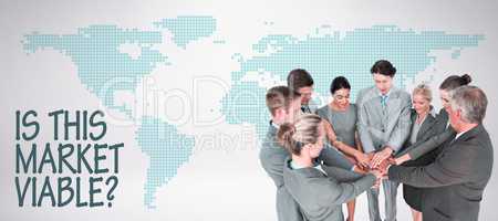 Composite image of smiling business team standing in circle hand