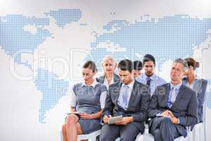 Composite image of business team taking notes during conference