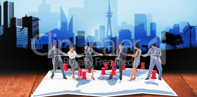 Composite image of business team pulling the rope