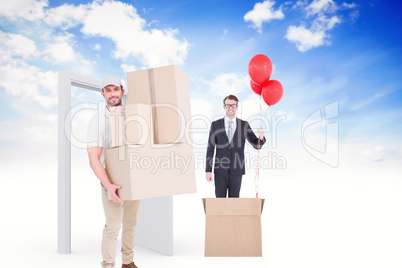 Composite image of delivery man carrying cardboard boxes