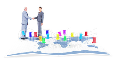 Composite image of businessman and woman shaking hands