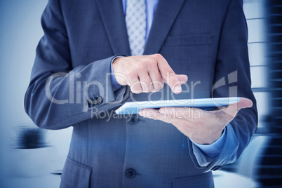 Composite image of businessman using tablet pc