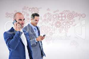 Composite image of business colleagues using phones