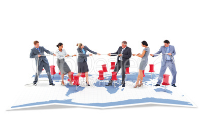 Composite image of business team pulling the rope