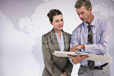 Composite image of business team looking at folder