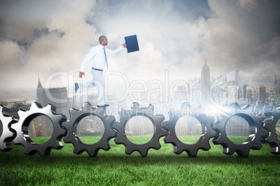 Composite image of businessman running with briefcase