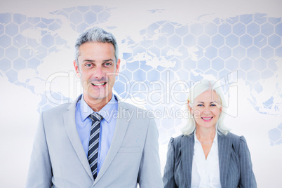 Composite image of  businessman and businesswoman smiling at the