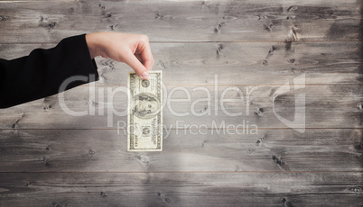 Composite image of businesswomans hand holding hundred dollar bi