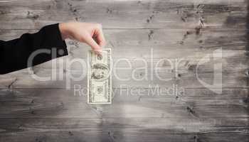 Composite image of businesswomans hand holding hundred dollar bi