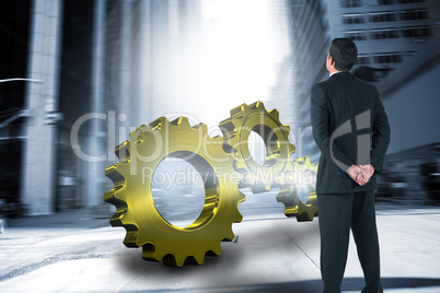 Composite image of businessman standing and looking