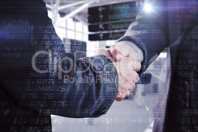 Composite image of business people shaking hands close up