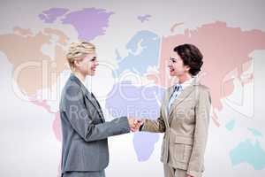 Composite image of  smiling women shaking hands