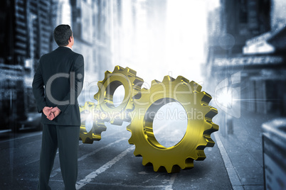 Composite image of businessman standing and looking