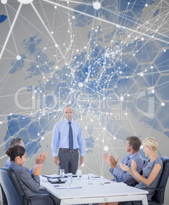 Composite image of business people applauding during meeting