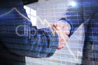 Composite image of business people shaking hands close up