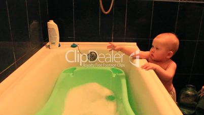 amusing baby wants to take a bath