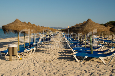 Sonnenliegen am Strand von Alcudia auf Mallorca