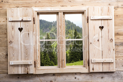 Wooden window with mountain reflections