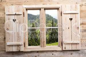 Wooden window with mountain reflections