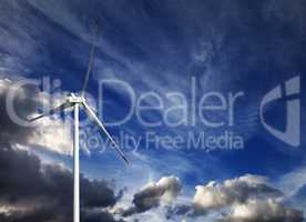 Wind turbine and blue sky with storm clouds