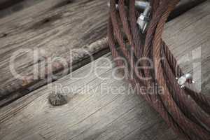 Abstract Rusty Iron Cable Laying on Old Wood Planks