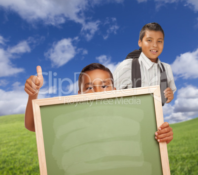 Hispanic Students with Thumbs Up in Grass Field Holding Blank Chalk Board.