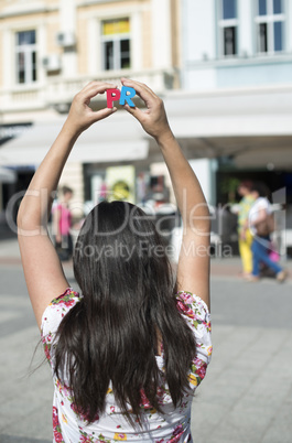 Women hold wooden letters PR