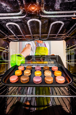 Baking macarons in the oven.