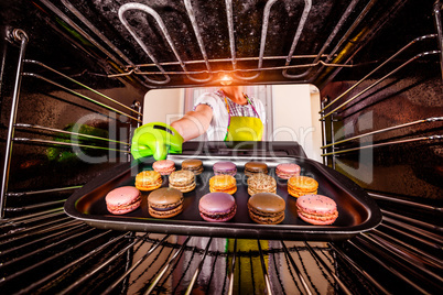 Baking macarons in the oven.