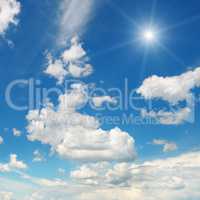 sun on blue sky with white clouds