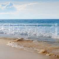 seascape, sand beach and blue sky