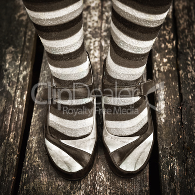 black and white Female legs in striped socks in vintage style