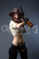 cowgirl with gun on gray background