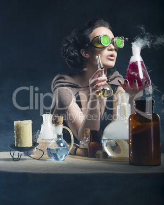 beautiful alchemist girl with test tubes in hand