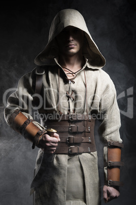 man in a cape with  knife  his hand