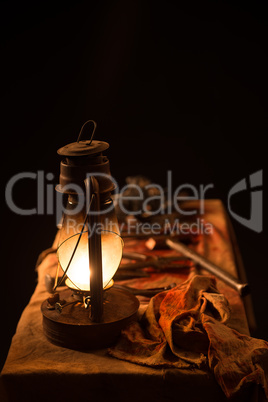 Lamp, knife and  mask on the table a gray background