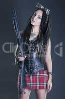 girl with dreadlocks and with gun in his hand on a gray background8