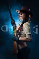 cowgirl  with gun on a gray background